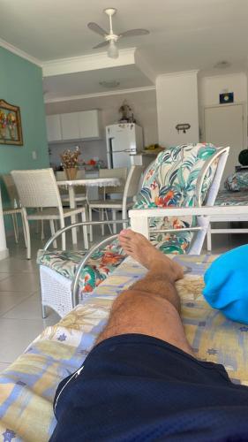 a man laying on a bed in a room at Apartamento Cobertura Monte Carlo in Ubatuba