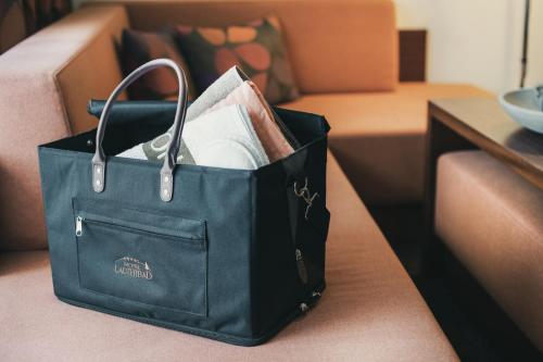 a black shopping bag sitting on a couch at Hotel Lauterbad in Freudenstadt