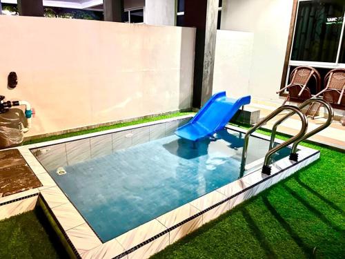 - une petite piscine avec toboggan dans une maison dans l'établissement Tokwan Homestay 2 - Homestay with private kid's pool, à Kuala Kedah