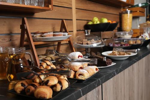 a buffet line with various pastries and other foods at Nobel Gallery Hotel in Belgrade