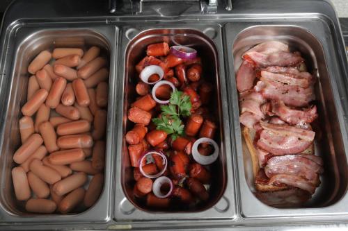 three trays of food with different types of food at Nobel Gallery Hotel in Belgrade