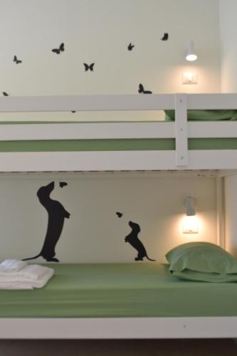 a bedroom with a bunk bed with a bear wall decal at L' Isola di Bacco in Porto Cesareo