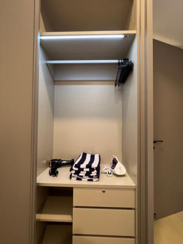 a walk in closet with a shelf and some items at EATON RESIDENCE KLCC BY JD in Kuala Lumpur