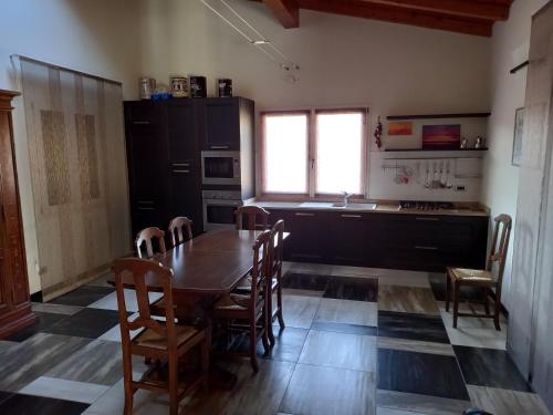 a kitchen with a table and chairs in a room at Ca' d Licio in Polinago