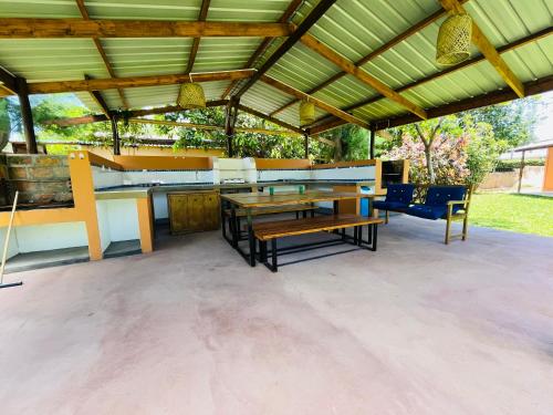 a patio with a table and chairs under a roof at Twin House #2 in Ponta do Ouro