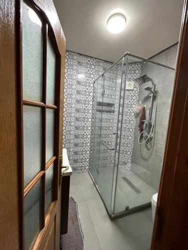 a bathroom with a shower with a glass door at Holikeys - El jadida - 2 Ch - Sidi Bouzid 001 in El Jadida