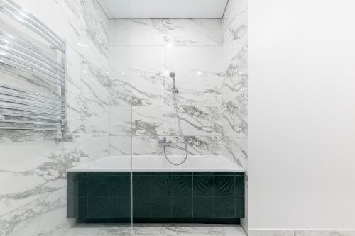 a bathroom with a shower with a bath tub at Vilnius legends house APARTMENT I Best for families I Free parking in Vilnius