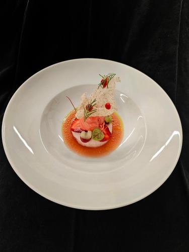 a white plate with a piece of food on it at Hotel Lauterbad in Freudenstadt