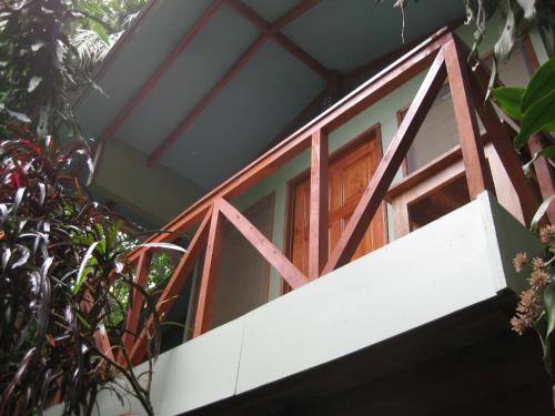 a tree house with a red and white window at Luz En El Cielo Eco-B&B/Hostel in Montezuma