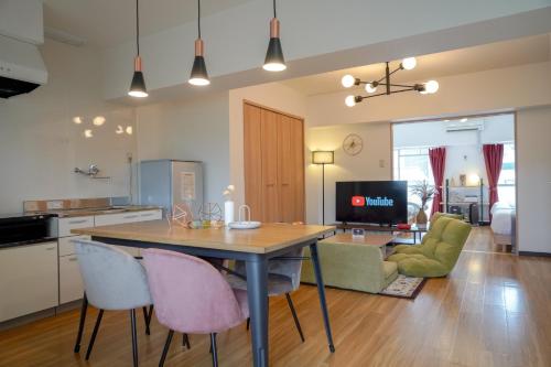 a kitchen and living room with a table and chairs at Allure axel 205 - Vacation STAY 54927 in Beppu