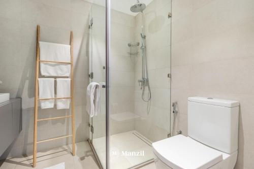 a bathroom with a shower and a toilet at Manzil - 1BR plus Maid in Dubai Sports City in Dubai