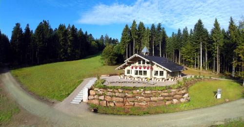 a house on top of a hill with a road at Hotel Lauterbad in Freudenstadt
