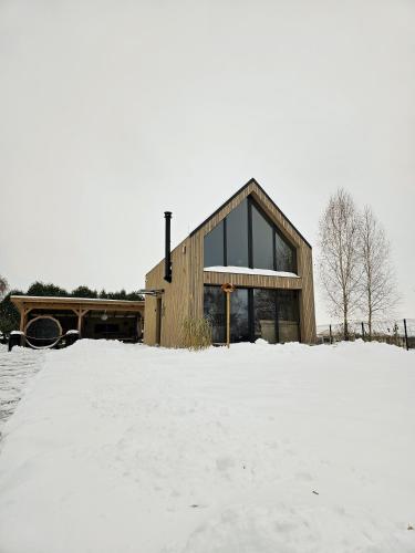 a house in the snow in front at Hytte Na Wyspie -,,Roztoczańskie Morze'' in Kulików