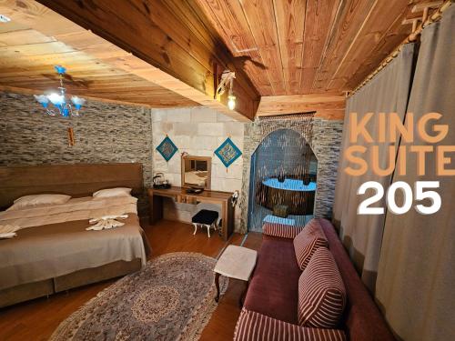 a bedroom with a king suite with a bed and a desk at Glorious House Goreme in Nevşehir
