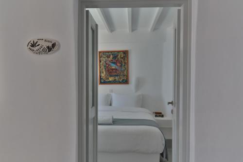 a bedroom with three beds in a room at Trieris Villa & Suites in Fira