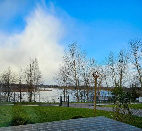 a park with a view of a body of water at Hytte Na Wyspie -,,Roztoczańskie Morze'' in Kulików