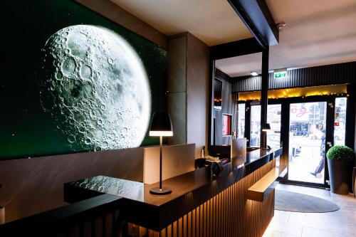 a restaurant with a large planet mural on the wall at Sleephotels Cosmos in Hamburg