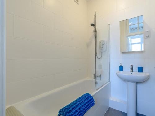 a white bathroom with a sink and a shower at 2 Bed in Bexhill-on-Sea 60137 in Bexhill