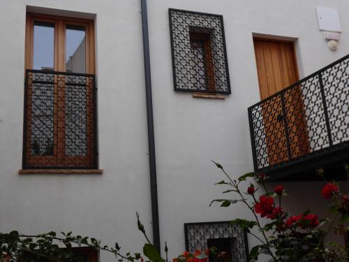 a white building with windows and a balcony at Casa de la escalera 1ª D in Córdoba