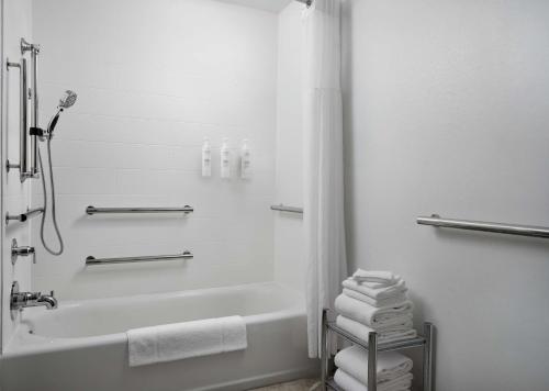 a white bathroom with a tub and a shower at Hampton Inn & Suites Austin - Downtown in Austin