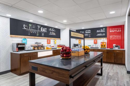 a fast food restaurant with a table with fruit on it at Hampton Inn & Suites Richmond in Richmond