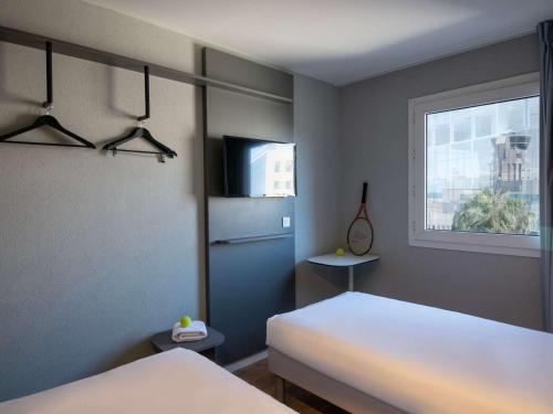 Postel nebo postele na pokoji v ubytování ibis budget Nice Aeroport