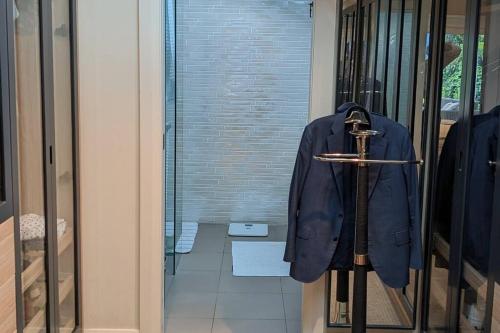 a blue jacket hanging on a rack in a door at Tranquil Escape at Balmoral Beach in Sydney