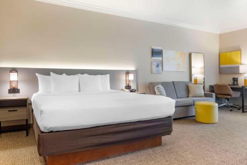 a bedroom with a large bed and a couch at Comfort Suites Oceanside Camp Pendleton Area in Oceanside