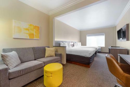 a hotel room with a bed and a couch at Comfort Suites Oceanside Camp Pendleton Area in Oceanside