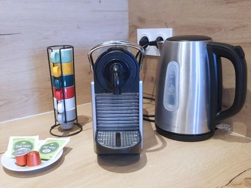 affeepot and a coffee maker on a table at Vue Montagne - Appt Cosy et calme - Netflix - Fibre in Grenoble