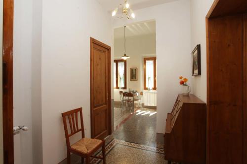 a hallway with a door and a chair and a table at Dimora Pieri in Florence