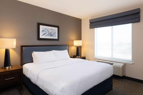 a bedroom with a large bed and a window at Hampton Inn San Jose Cherry Ave, CA in San Jose