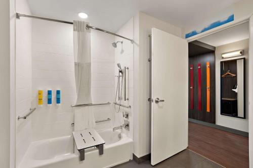 a white bathroom with a shower and a tub at Tru By Hilton Santee in Santee