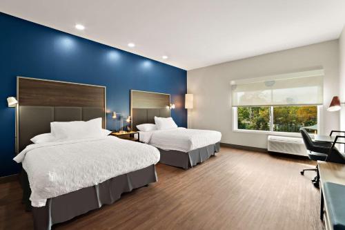 a hotel room with two beds and a window at Tru By Hilton Santee in Santee