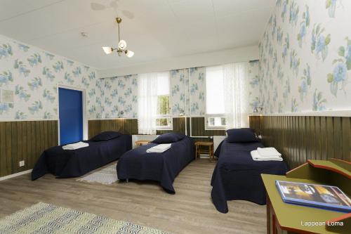 a hospital room with four beds in it at LappeanLohi in Lappea