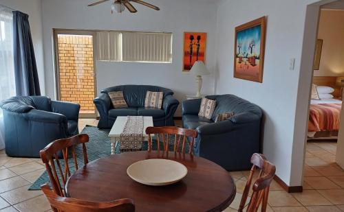 a living room with a table and chairs at Kleinmond Panorama Holidays in Kleinmond