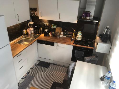 a small kitchen with white cabinets and a sink at Helios house in Antalya