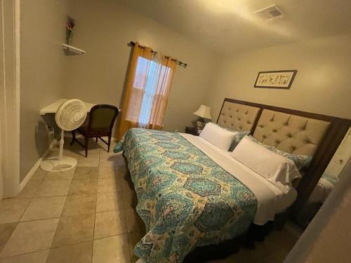 a bedroom with a bed and a chair and a desk at Cozy 3Bdr 2Bth 1st floor Unit in New Orleans