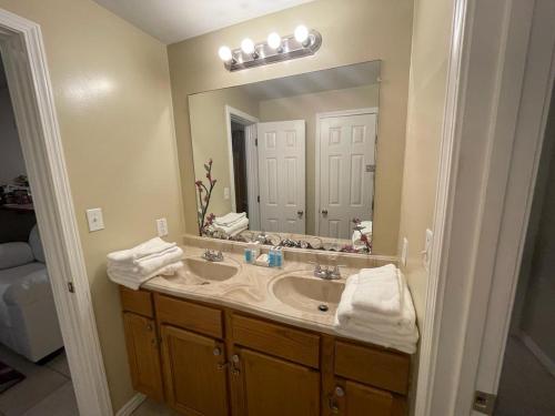 a bathroom with a sink and a large mirror at Cozy 3Bdr 2Bth 1st floor Unit in New Orleans