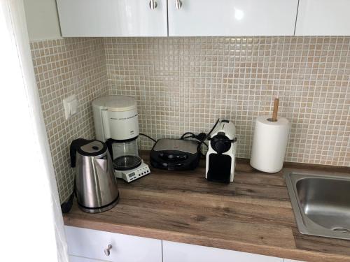 a kitchen counter with various appliances on a counter top at Lamia central luxury apartment in Lamía
