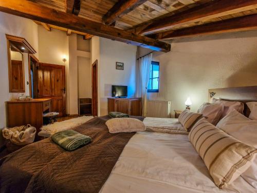 a large bed with pillows on it in a room at 8BD Retreat in Bansko Comfort & Mountain Charm by Flat Mаnager in Bansko