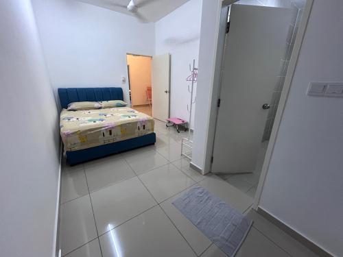a bedroom with a bed in a white room at Cool Gateaway Seremban Homestay in Labu