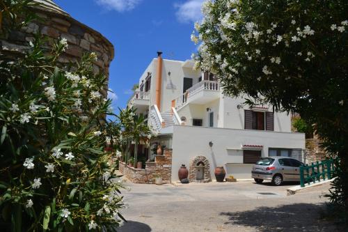 a building with a car parked in front of it at Stelios Zalonis Apartments in Tinos Town