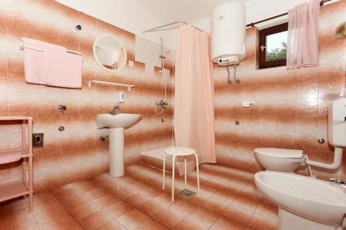 a bathroom with a toilet and a sink at Apartments Spavalo in Pag