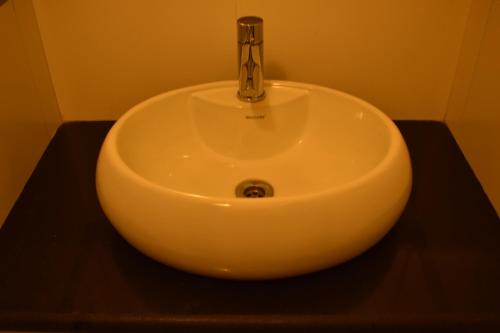 a white sink with a faucet in a bathroom at Ornate Villa in Pune