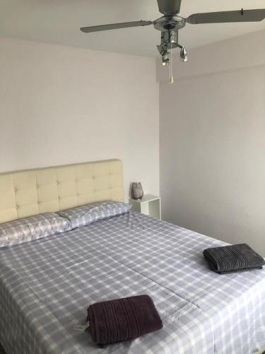 a bedroom with a bed with two towels on it at Terraza Albir in Albir