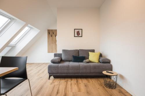 a living room with a couch and a table at myQuartier Central City Suites in Innsbruck