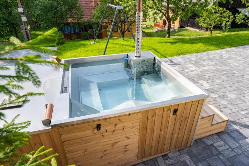 a jacuzzi tub in a backyard at Apartmány pod Rozsutcom - Zaťkov dvor in Terchová