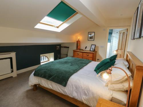 a bedroom with a large bed and a skylight at Lee House Farm in Halifax