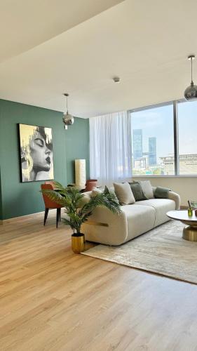 a living room with a couch and a table at LUXURY SPACIOUS - 1 BR - SKY GARDENS DIFC - Heart of Trade Centre and Dubai Mall in Dubai
